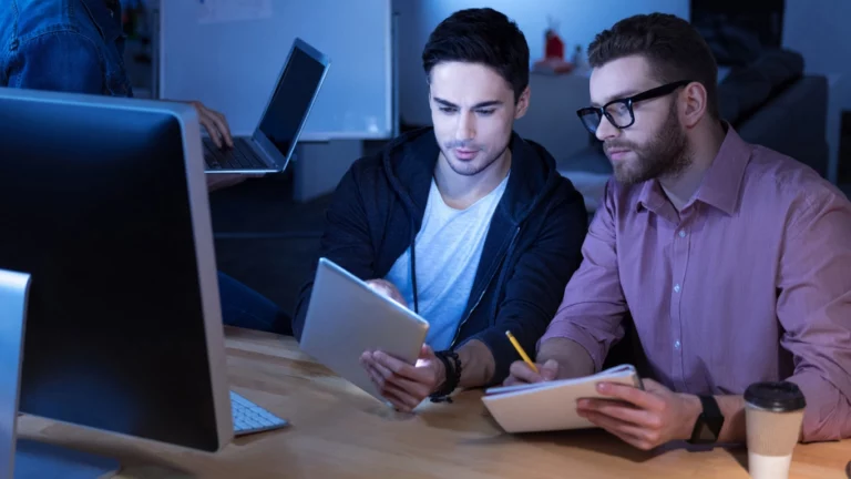 two-male-man-in-office-in-front-of-computer-with-low-light