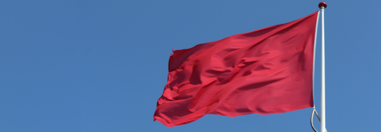 red-flag-on-a-blue-sky-background